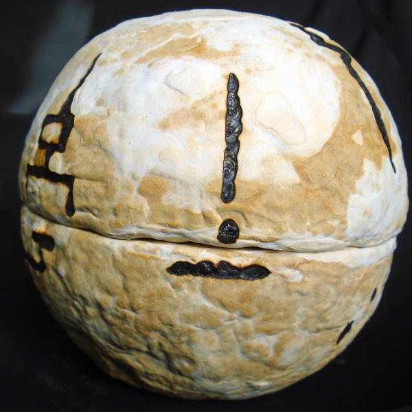 A mycelium sphere covered in black glyphs.